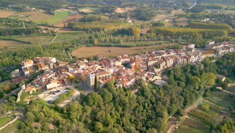 Hostalric-aerial-images-medieval-town-in-Catalonia-touristic-castle-on-top-of-the-mountain-Spectacular-aerial-view-with-AVE-train,-high-speed-bullet