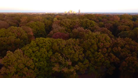 Reverse-Aerial-of-Downtown-Winston-Salem-with-Fall-Leaves