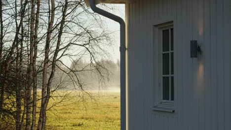 Time-lapse-of-morning-fog-moving-at-Nordic-countryside-home