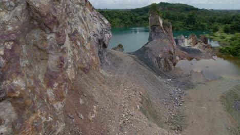 Close-shot-on-stone-quarry-with-crystal-clear-lake-and-mountain-view-in-Thailand