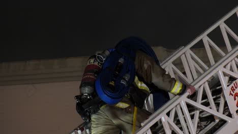 lone-firefighter-walks-up-ladder