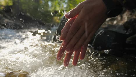 Slow-Motion-Closeup-of-a-Person-Washing-Hands-in-a-River