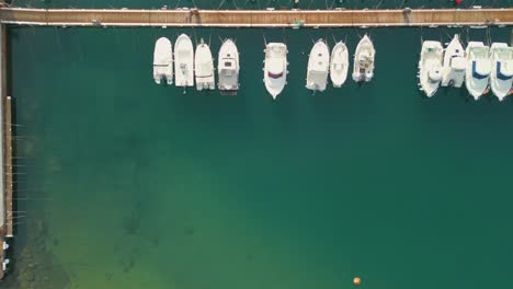 Aerial-view-of-small-boats-in-a-port-slow-scrolling-to-the-right-space-for-logos-and-text-copy-space