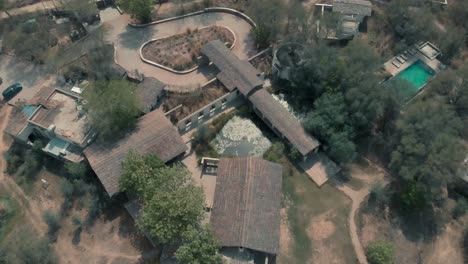 Sariska-national-park-in-India,-villas,-green-trees,-Drone-spiral-shot-4K
