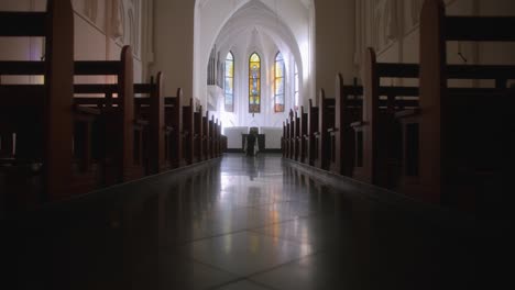 Holy-path-in-church-empty-seats-monk-sitting-in-front-of-altar