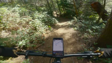 Mountain-biking-on-fast-smooth-banking-and-rolling-hills-in-the-pacific-northwest-with-phone-navigation-on-bike-handlebars
