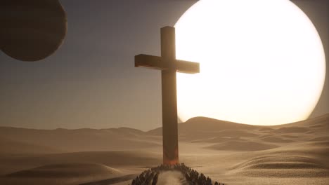 A-huge-gold-cross-on-the-desert-with-people-walking-towards-it,-a-planet-on-the-sky,-and-a-big-sunset-3D-animation