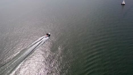 Aerial-drone-footage-following-motorboats-on-Lake-Biel-and-showing-off-the-blue-waters-and-gorgeous-scenery