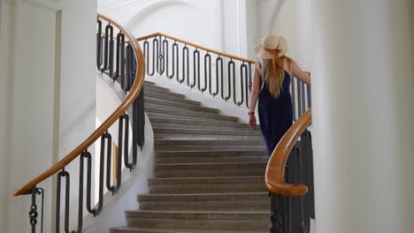 Woman-ascends-the-stairways-in-Baroque-style-at-Jelgava-Palace,-Latvia