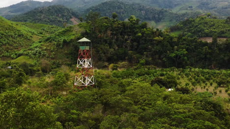 Aerial-pullback,-fire-lookout-tower-in-tropical-rainforest