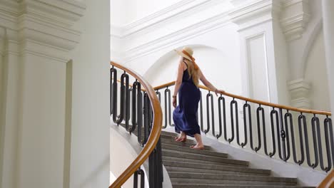 Woman-in-Dress-Going-Up-a-Staircase-in-Baroque-style-at-Jelgava-Palace,-Latvia