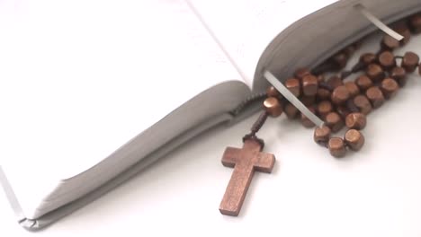 praying-to-god-with-bible-and-cross-on-a-table-with-white-background-stock-video