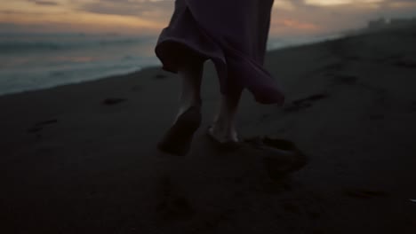 Barefooted-Woman-Walking-On-The-Beach-Leaving-Footprints-On-The-Sand
