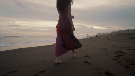 Attractive-Woman-Wearing-Dress-Walking-On-The-Sandy-Shore-Barefooted