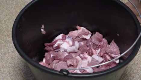 Fresh-pork-pieces-in-a-bucket-for-barbecue,-meat-separating-porcess