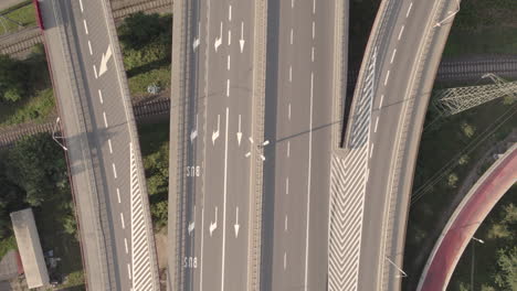 Aerial-top-down-on-empty-modern-road-junction-in-a-large-megapolis,-fork-in-the-road-in-Gdynia-city