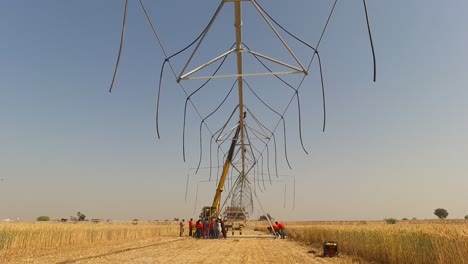 Timelapse-of-group-of-men-raising-the-pipes-of-Center-Pivot-Irrigation-System-in-Pakistan