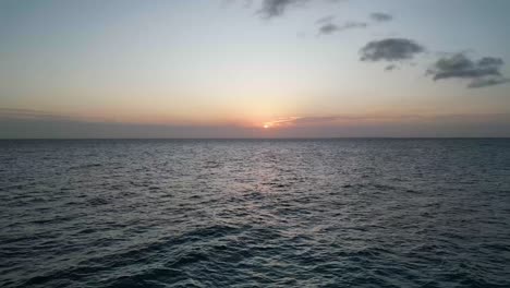 Sunset-over-the-Indian-Ocean-at-Kusini-beach-East-Zanzibar-Island,-Tanzania-Africa,-Aerial-fast-flyover-shot