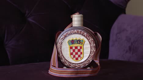 Brandy-bottle-with-Croatian-national-symbols,-handheld-shoot