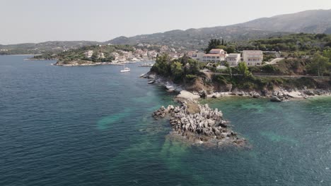 Aerial-View-Of-island-Reef-Outcrop-With-Hotel-At-Kassiopi,-Corfu