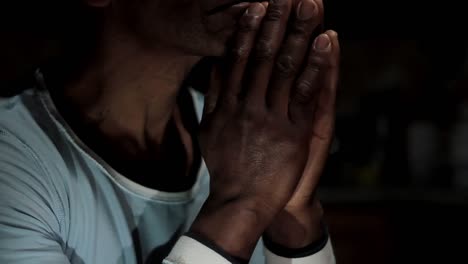 man-praying-to-god-with-hands-together-on-black-background-stock-video-stock-footage