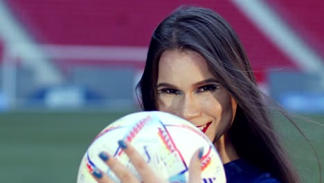 Attractive-Brazilian-brunette-smiles-and-plays-with-football