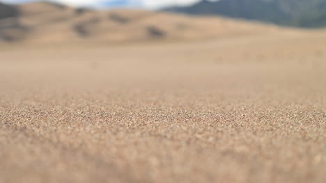 Close-Up-Grains-of-Sand-Blowing-in-the-Wind-in-the-Middle-of-Desert-in-4K