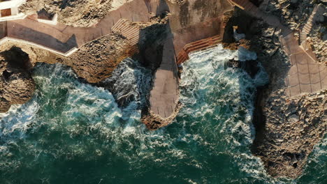 Ocean-Waves-Crashing-On-Rocky-Coastline-Of-Citta-del-Mare-Perla-Del-Golfo-In-Summer-In-Terrasini,-Palermo,-Sicily,-Italy