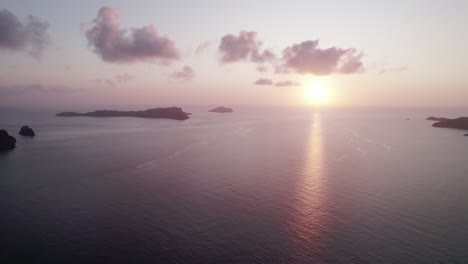 Fast-Keine-Wolken-Bei-Orangefarbenem-Sonnenuntergang-Mit-Ruhigem-Meer-Und-Inseln,-Luftaufnahme