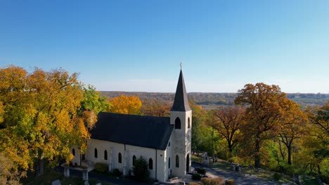 Old-Church-and-Cemetery-In-Colorful-Autumn-Forest-Drone
