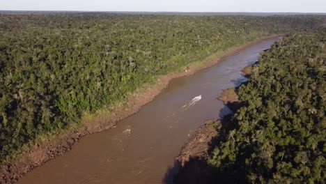 Motorboat-along-Iguazu-River-crossing-Amazon-rainforest-at-border-between-Brazil-and-Argentina