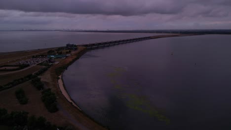 Aerial-view-of-water-surface-and-road-on-Haringvliet-sluices-under-overcast-sky
