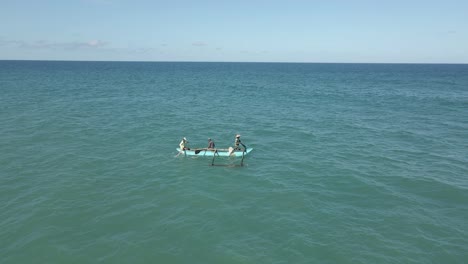 Aerial-Drone-Shot-of-Men-Paddling-Small-Traditional-Fishing-Boat