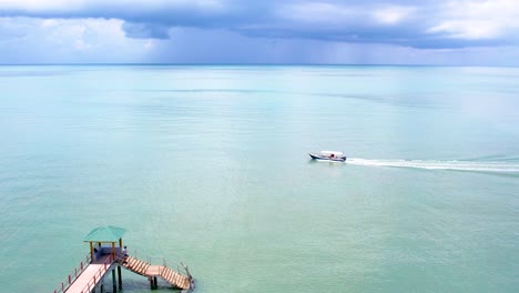 Beautiful-beach-and-motor-boat-in-Malaysia,-drone-view