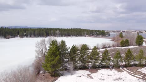 floating-over-the-pines-Drone-Aerial-of-the-winter-showing-the-vacation-homes-around-Island-Park-Reservoir-in-Island-Park-Idaho