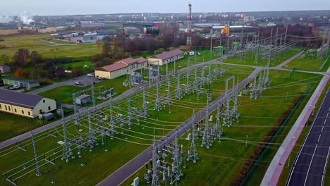 Aerial-drone-rotating-shot-over-a-high-voltage-power-distribution-substation-on-a-cloudy-day