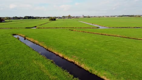 Aerial-video-of-empty-Dutch-pasture-fields,-separated-by-creeks