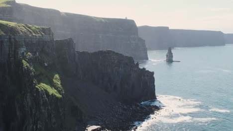 Slow-zoom-out-on-epic-cliffs-of-Moher-vista-backlit-with-sunshine