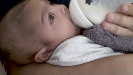 2-Month-Old-Indian-Baby-Boy-Attempting-To-Drink-Milk-From-Bottle-And-Fidgeting