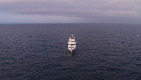 Descending-aerial-shot-with-tilt-up-of-a-secluded-boat-alone-at-sea