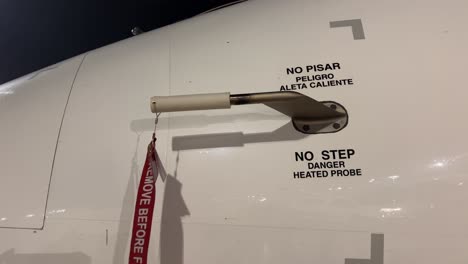 Pilot-putting-the-Remove-Before-Flight-label-pitot-cover-for-a-medium-size-jet’s-overnight
