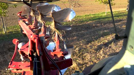 Heavy-tractor-plowing-land-field-on-sunny-day,-view-from-inside