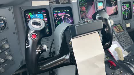 Close-view-inside-a-jet-cockpit-of-the-captain-control-wheel-in-a-moder-cristal-cockpit