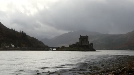 Eilean-Donan-Castle,-Highlands,-Scotland,-with-dark-moody-skies-and-clouds