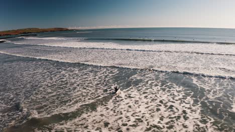 Garretstown-Beach,-Cork,-Ireland,-surfers-and-waves