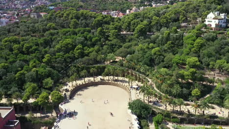 Parc-Guell-in-Barcelona,-seen-from-above-over-the-tree-tops,-summer