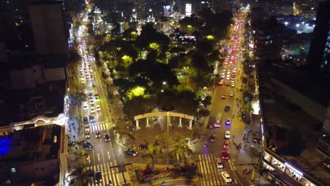 Drone-4k-aerial-video-of-night-time-Lima-Peru,-of-"Parque-Kennedy"-or-"Kennedy-Park"-in-Miraflores-district