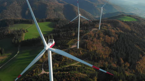 Three-turning-wind-turbine-in-the-forest-clip-30fps-4k