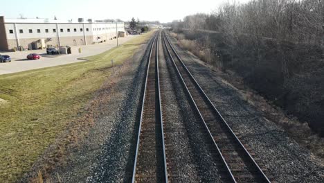 First-person-view-of-train-tracks,-trace-upward-for-larger-view