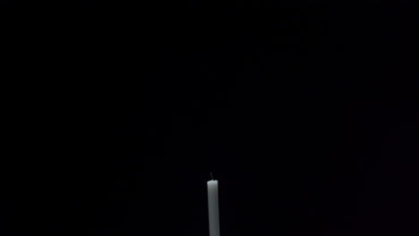 a-candle-is-being-lit-with-a-matchstick